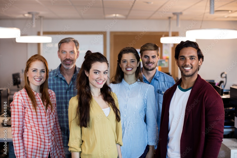 Creative business team standing together in office Creative business team standing together in office