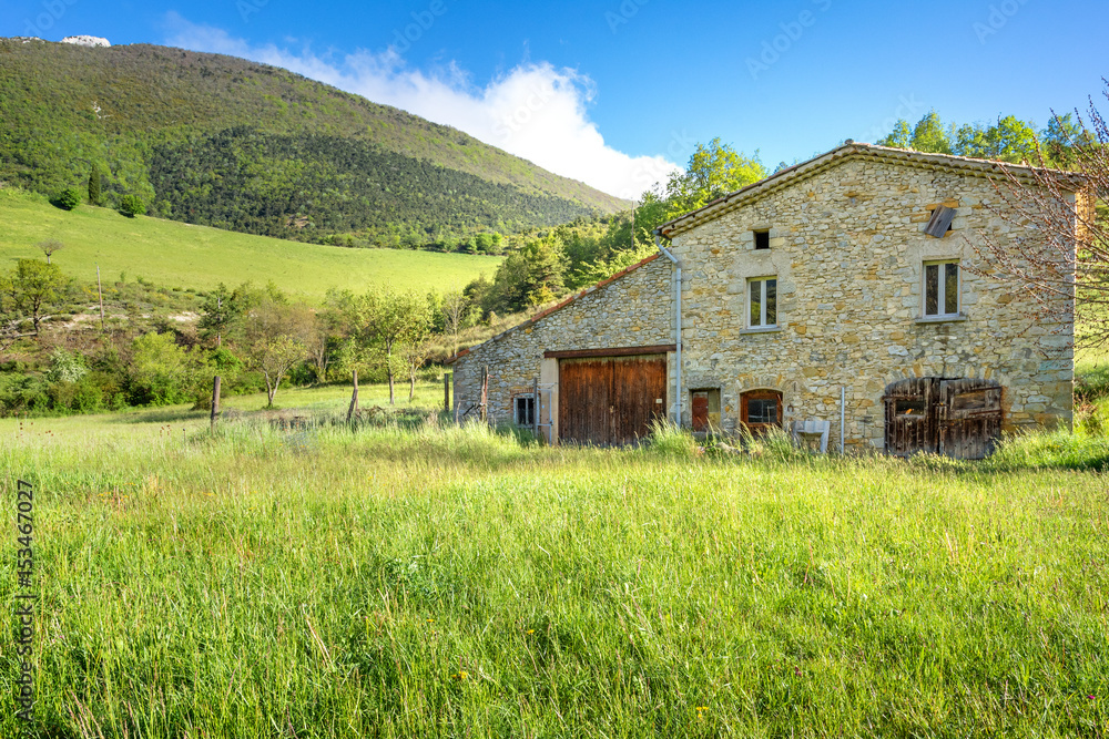 French countryside. Typical old farm with mountains in the background in Vercors, France. French countryside. Typical old farm with mountains in the background in Vercors, France.