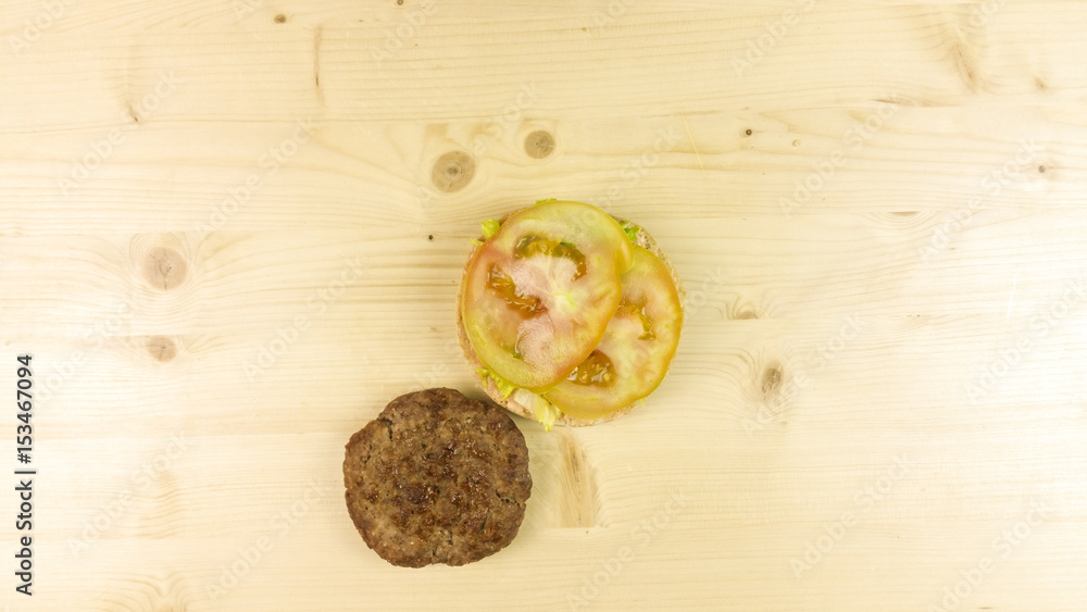 Making burger and chips on wooden background - top view Making burger and chips on wooden background - top view