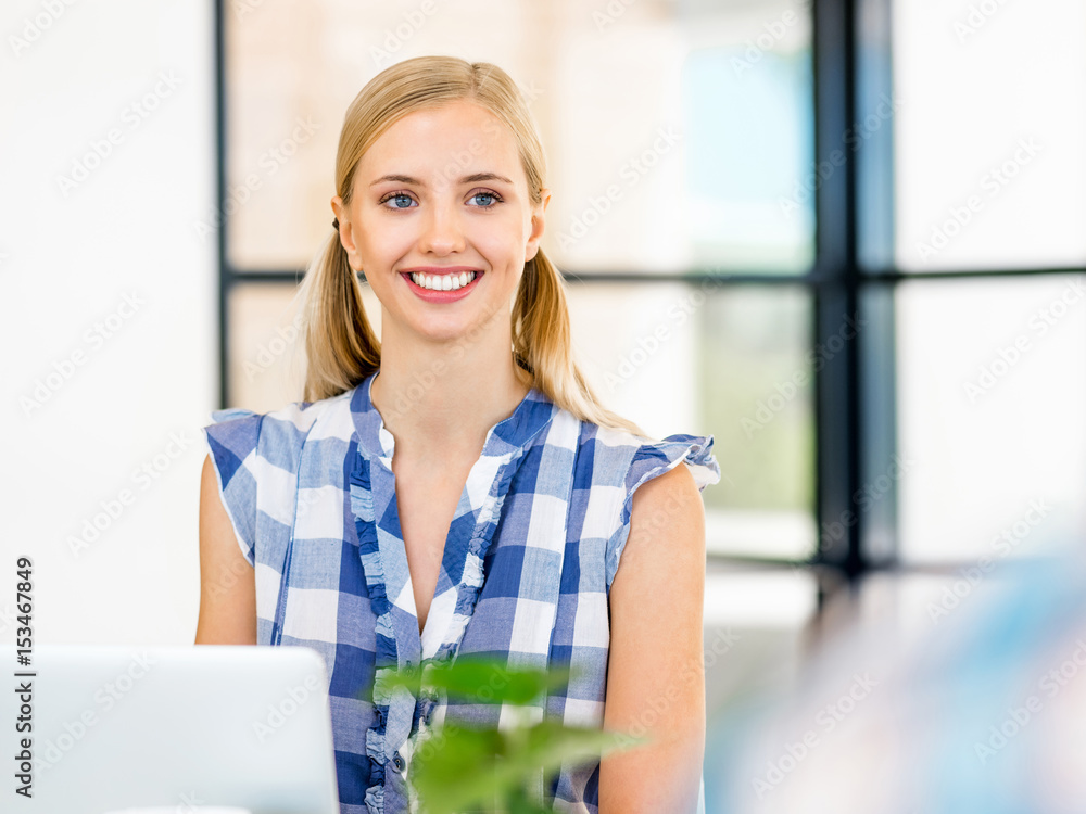 Young woman smiling in office Young woman smiling in office