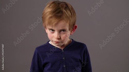 free little boy shaking his head to express his boredom