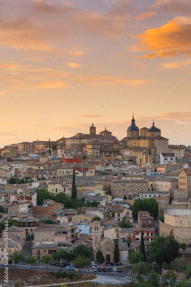 Toledo cathedral on hill top at sunset