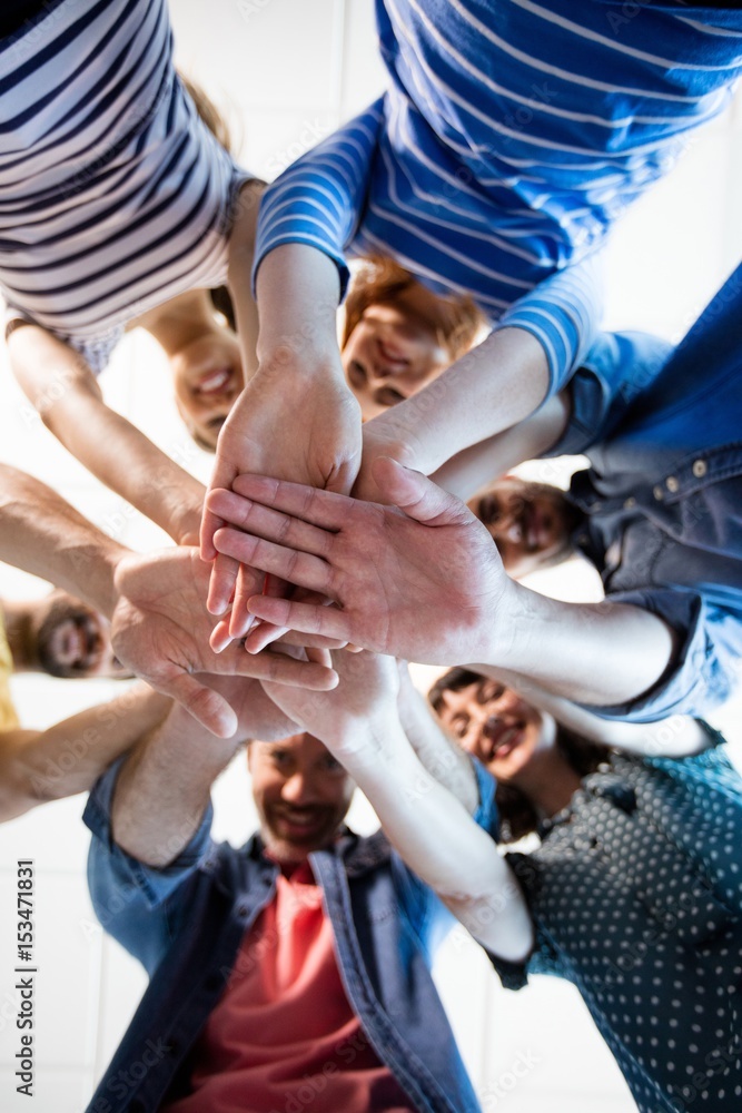 Fototapeta premium Creative business team stacking hands together