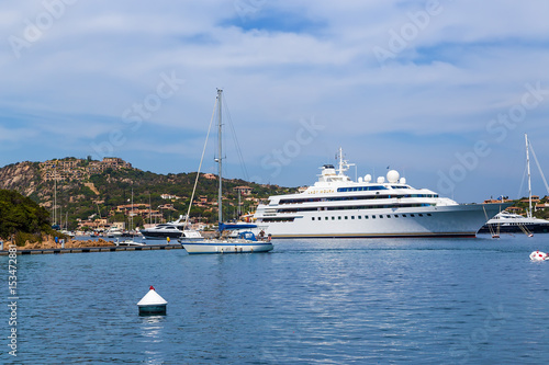 The island of Sardinia, Italy. Picturesque bay and yachts in Porto Cervo against the backdrop of the mountains