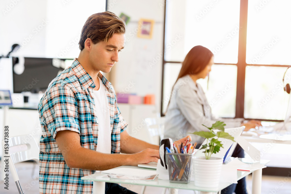 Fototapeta premium Young man working in office