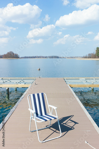 summer pier chair in the lake