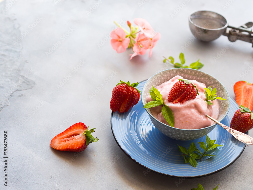 Home made strawberry ice cream in bowl with min leaves Home made strawberry ice cream in bowl with min leaves