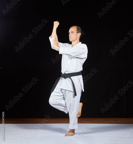 Adult athlete makes a block with his hands on a black background Kaderov