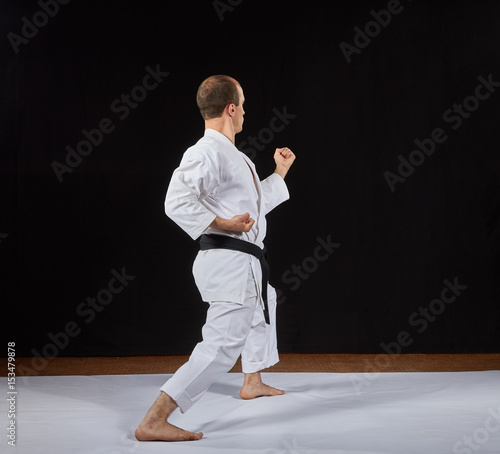 In a karate stand, a sportsman makes a block with his hand Kaderov