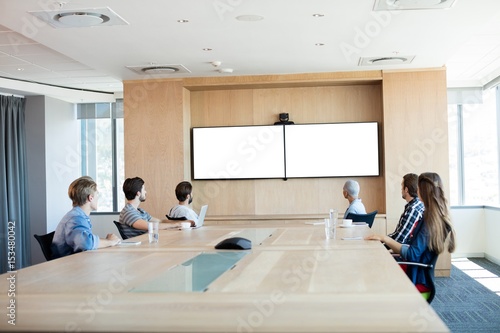 Obraz na plátně Creative business team attending a video call in conference room