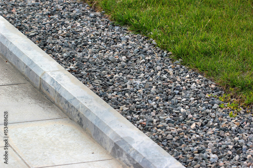 Border kerb between lawn and sidewalk in a park photo