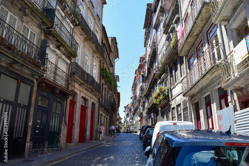 Unidentified people walk through the narrow streets of Ribeira in Porto, Portugal