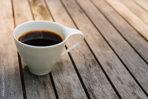 Cup of coffee on wooden background and copy space