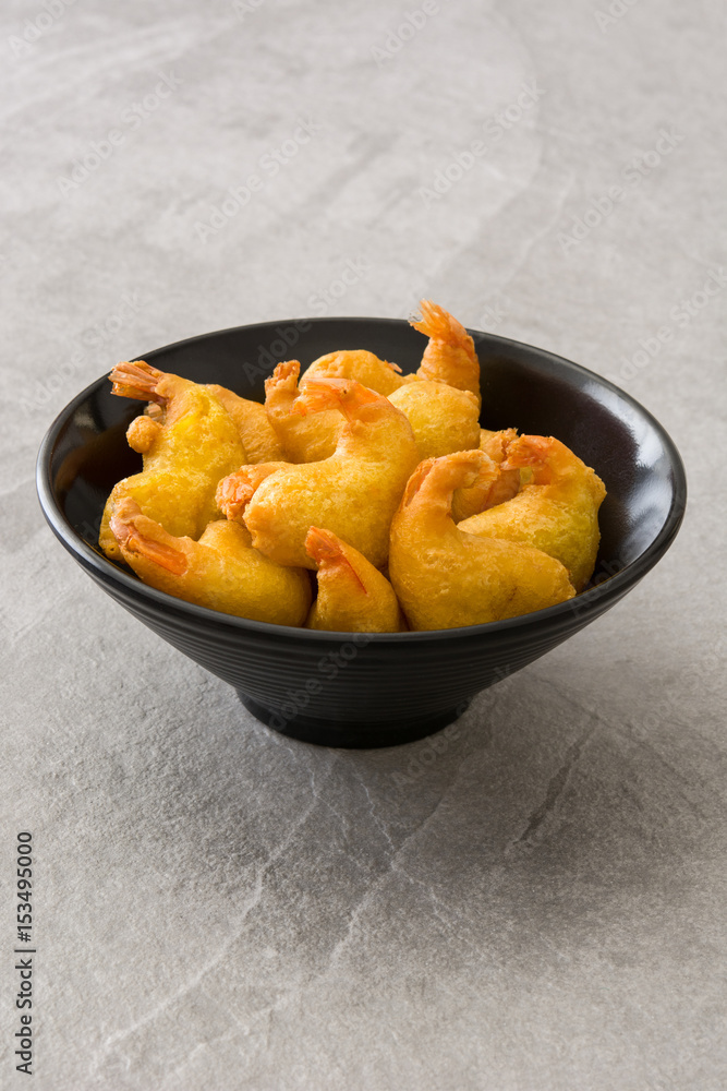 Deep fried shrimps in a bowl on gray stone
Deep fried shrimps in a bowl on gray stone