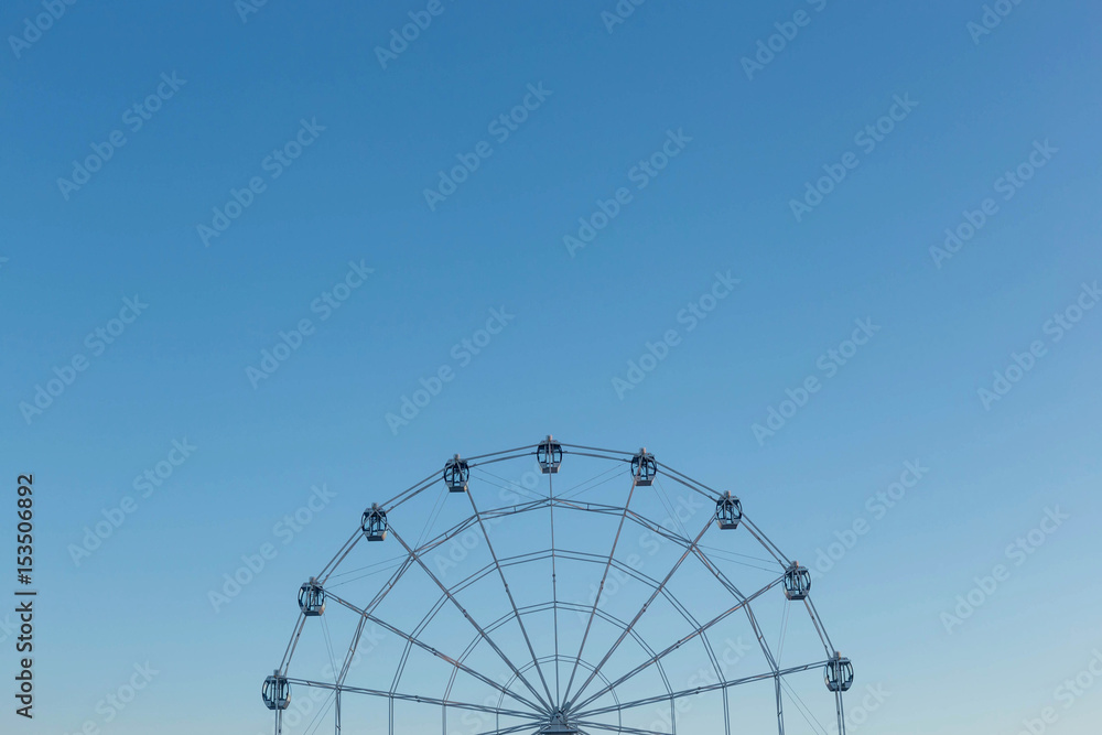 Fototapeta premium Ferris wheel against blue sky background