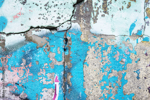 Blue and cyan paint on a cracked old wall photo