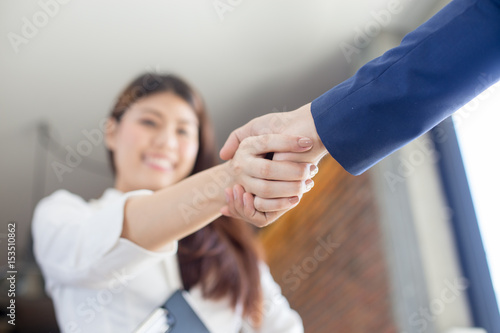 Asian businesspeople shaking hands greeting each other
