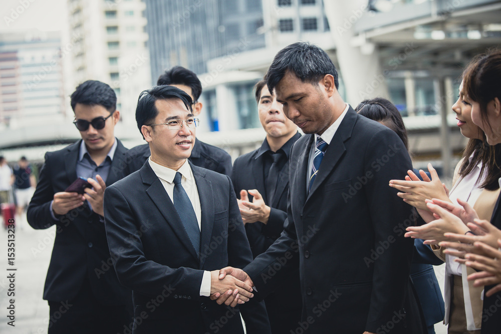 Asian businessmen handshaking after striking grand dealม 30-40 yeal old, vintage tone. Asian businessmen handshaking after striking grand dealม 30-40 yeal old, vintage tone.