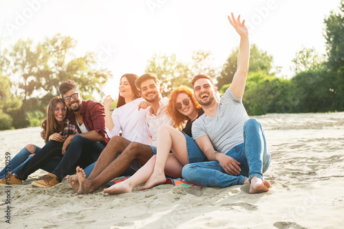 Group of young people having fun outdoors on the beach 
