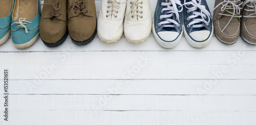 The shoes are placed on a white wooden floor.