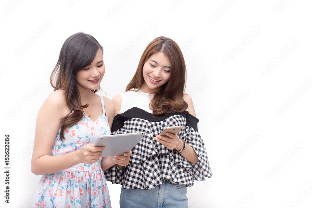 Protrait beautiful asian women use tablet shopping with friend, happy emotion concept, isoalted white background, shopping protrait concept, 20s year old. Protrait beautiful asian women use tablet shopping with friend, happy emotion concept, isoalted white background, shopping protrait concept, 20s year old.