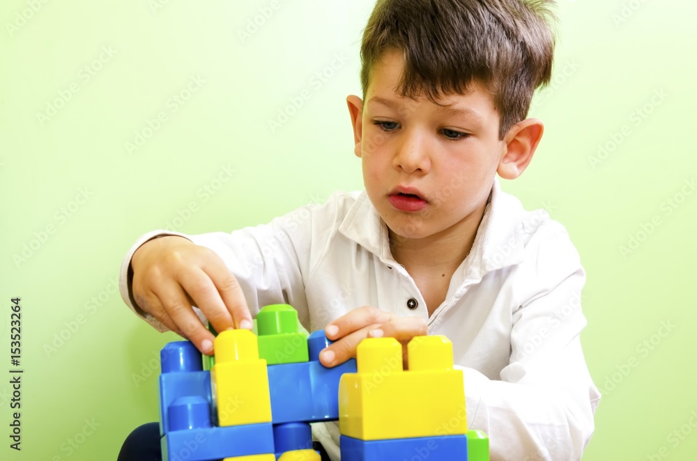 boy playing with construction toy blocks boy playing with construction toy blocks