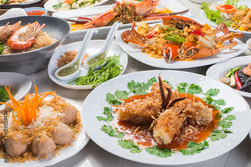 seafood in Restaurant, white plate on the Table , group many variety of meal