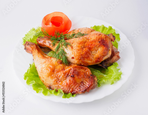 Grilled chicken legs with lettuce on plate