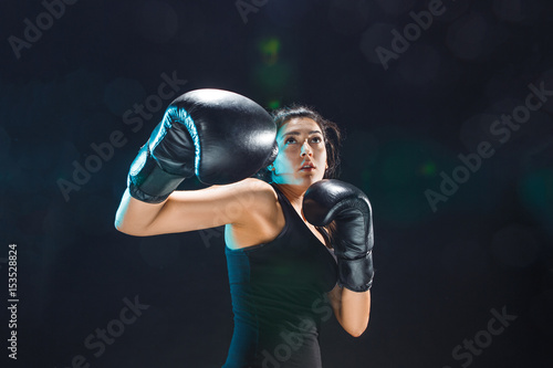 The female boxer training at sport club © master1305