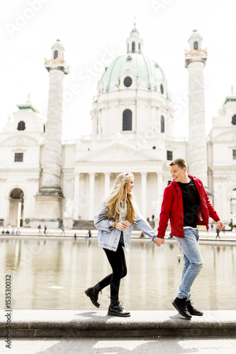 Young couple walking holdin...