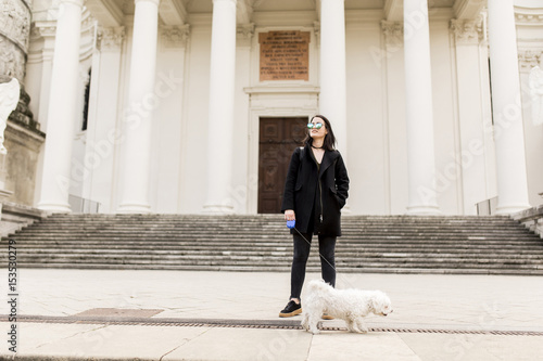 Woman walking with a dog on...