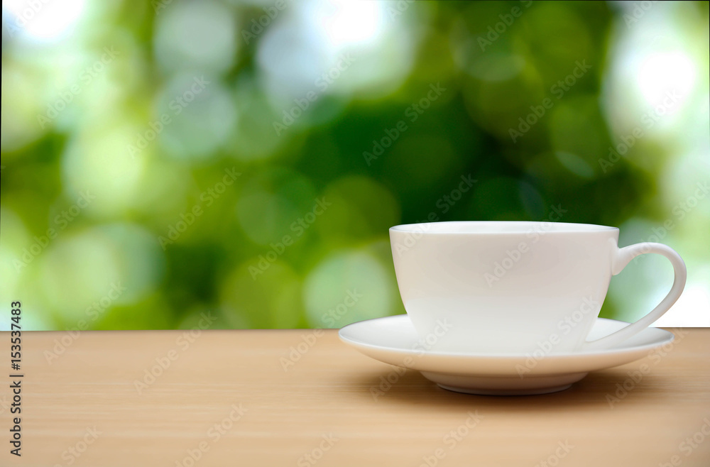 coffee cup on wood table. green bokeh nature background coffee cup on wood table. green bokeh nature background