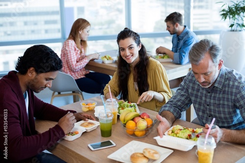 Creative business team having meal in office