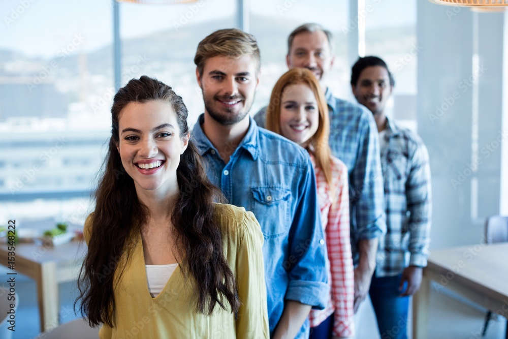 Fototapeta premium Happy creative business team standing in a line