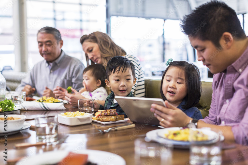 Children with parents enjoying at restaurant Children with parents enjoying at restaurant