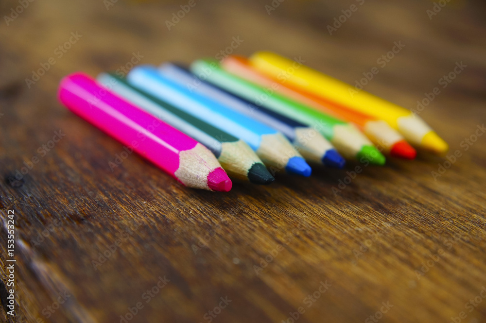 Colourful colour pencil over wooden table on summer background Colourful colour pencil over wooden table on summer background