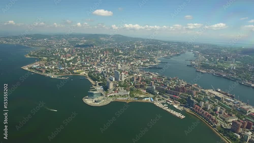 Vladivostok skyline Golden Horn and Amursky bay. Modern center cityscape capital of Primorsky Krai. Commerce port yacht. Tourist hotel international business. Unique aerial drone great height forward Vladivostok skyline Golden Horn and Amursky bay. Modern center cityscape capital of Primorsky Krai. Commerce port yacht. Tourist hotel international business. Unique aerial drone great height forward