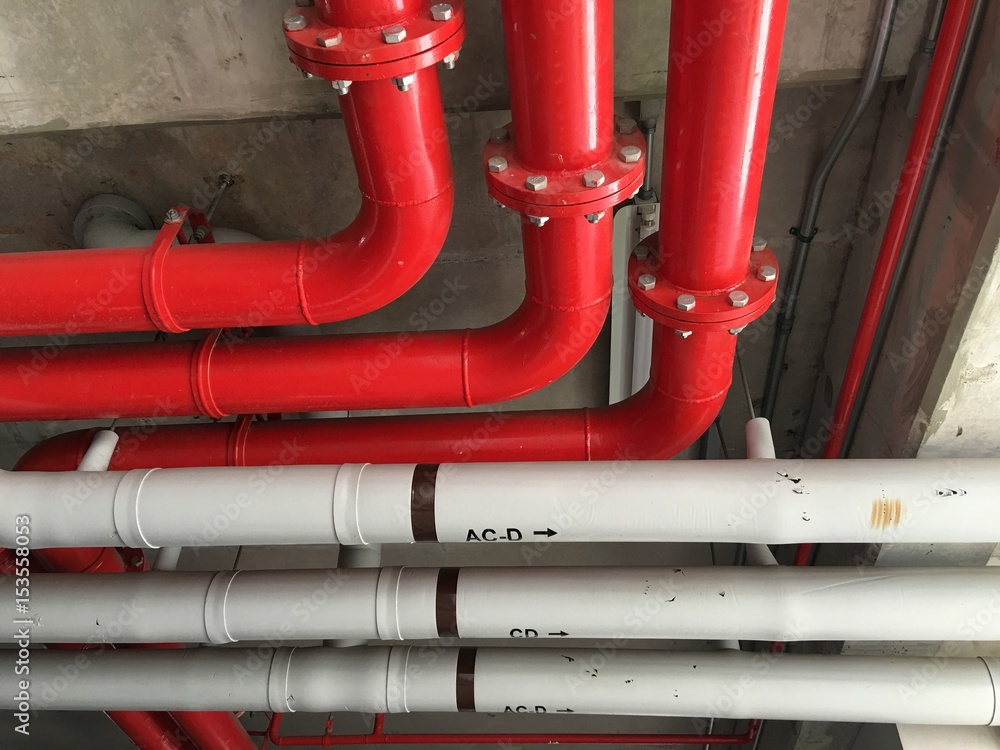 Bare skin ceiling show red pipeline on concrete ceiling.