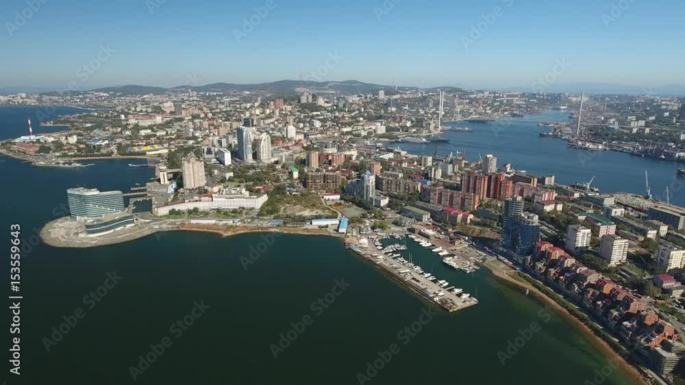 Vladivostok skyline Golden Horn and Amursky bay. Modern center cityscape capital of Primorsky Krai. Commerce port yacht. Tourist hotel international business. Unique aerial drone great height drift Vladivostok skyline Golden Horn and Amursky bay. Modern center cityscape capital of Primorsky Krai. Commerce port yacht. Tourist hotel international business. Unique aerial drone great height drift