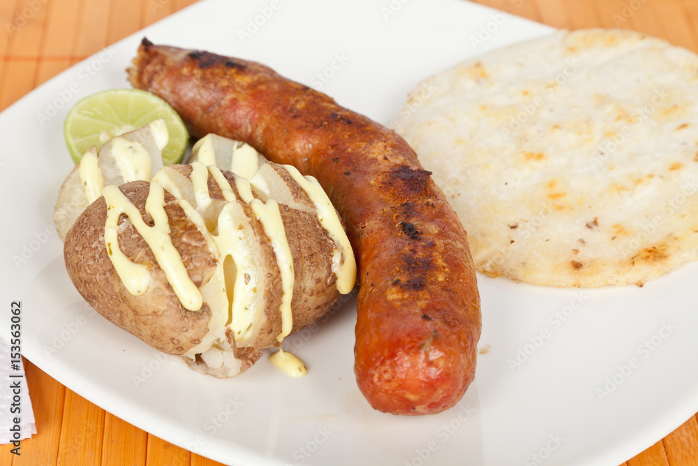 Grilled Sausage with arepa and cooked potato Grilled Sausage with arepa and cooked potato