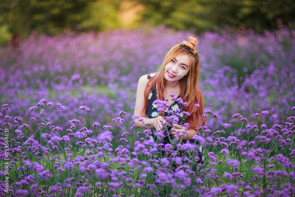 Beautiful Asian girl is smiling in purple flower field Beautiful Asian girl is smiling in purple flower field