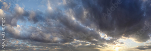 Panorama of the sunset with storm clouds