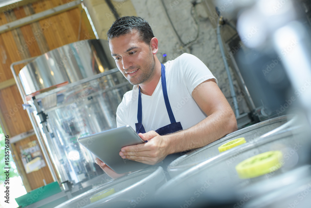 confident brewer ordering supplies on his tablet confident brewer ordering supplies on his tablet