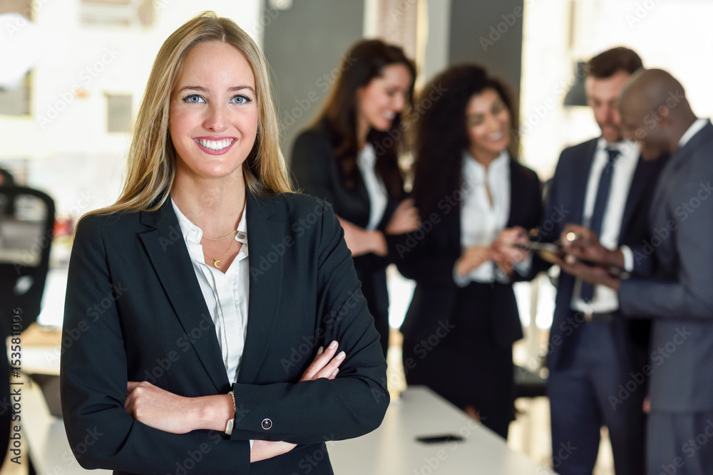 Businesswoman leader in modern office with businesspeople working at background Businesswoman leader in modern office with businesspeople working at background