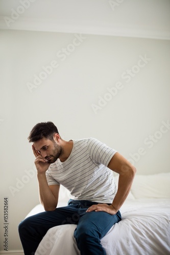 Worried man sitting in the bedroom © WavebreakMediaMicro