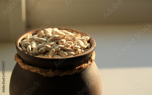 White beans in a ceramic cup. photo