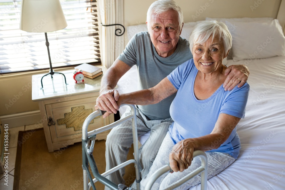Senior man consoling woman in bedroom Senior man consoling woman in bedroom