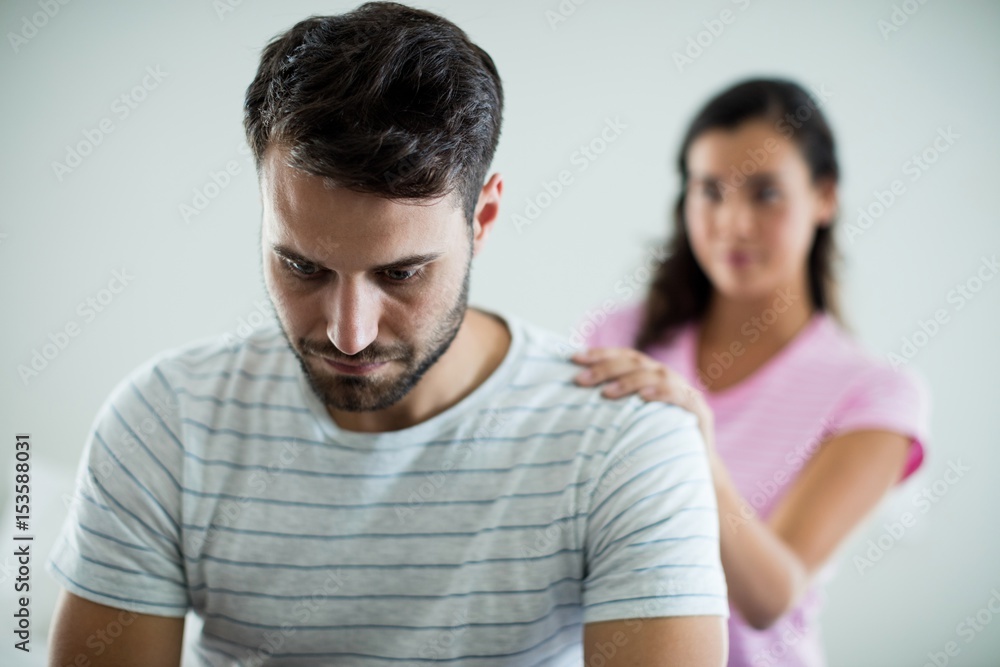 Fototapeta premium Upset couple sitting on bed in the bedroom