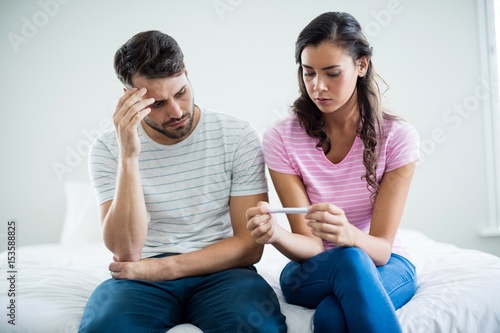 Worried couple finding results of a pregnancy test  photo