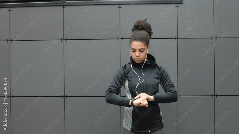Female runner using activity tracker after workout Female runner using activity tracker after workout